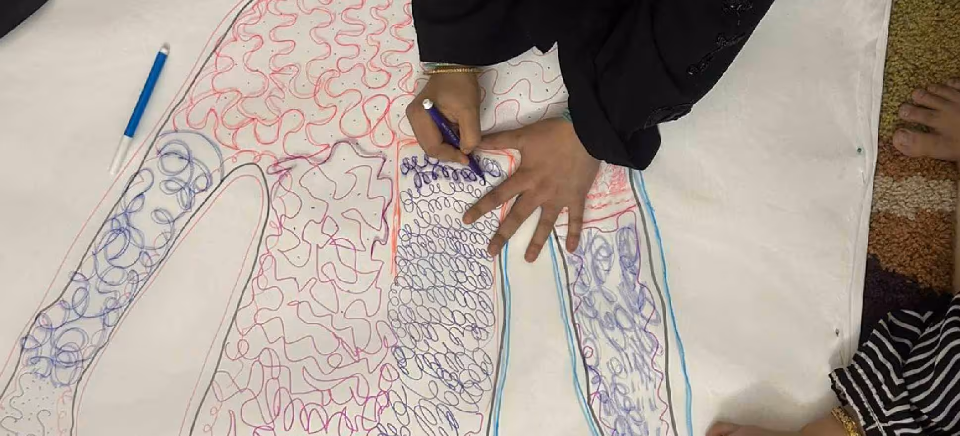 Participant creating a colourful stitched artwork during the Khatta Meetha workshop at KNMA.